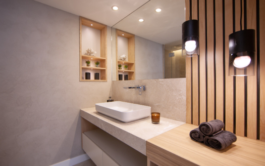 A contemporary bathroom showcasing minimalist design and warm lighting.