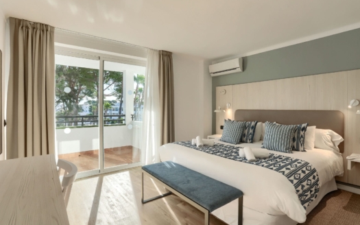 Bright modern bedroom with balcony and large bed